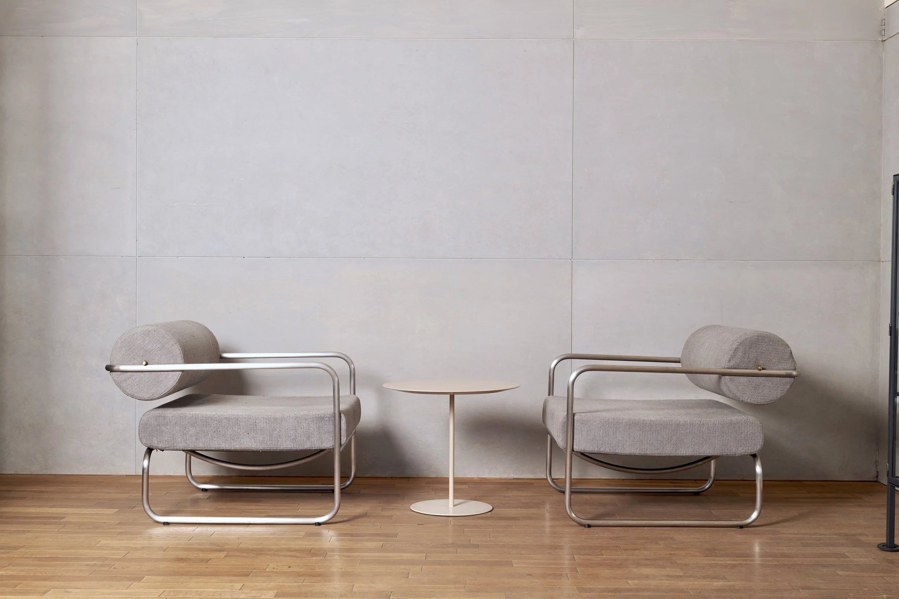 Two lounge chairs by Takashi Kita with a small table between them
